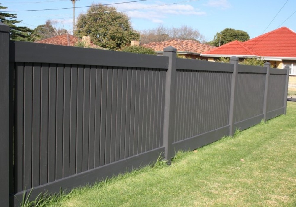 Neatly painted timber fence line on a residential property